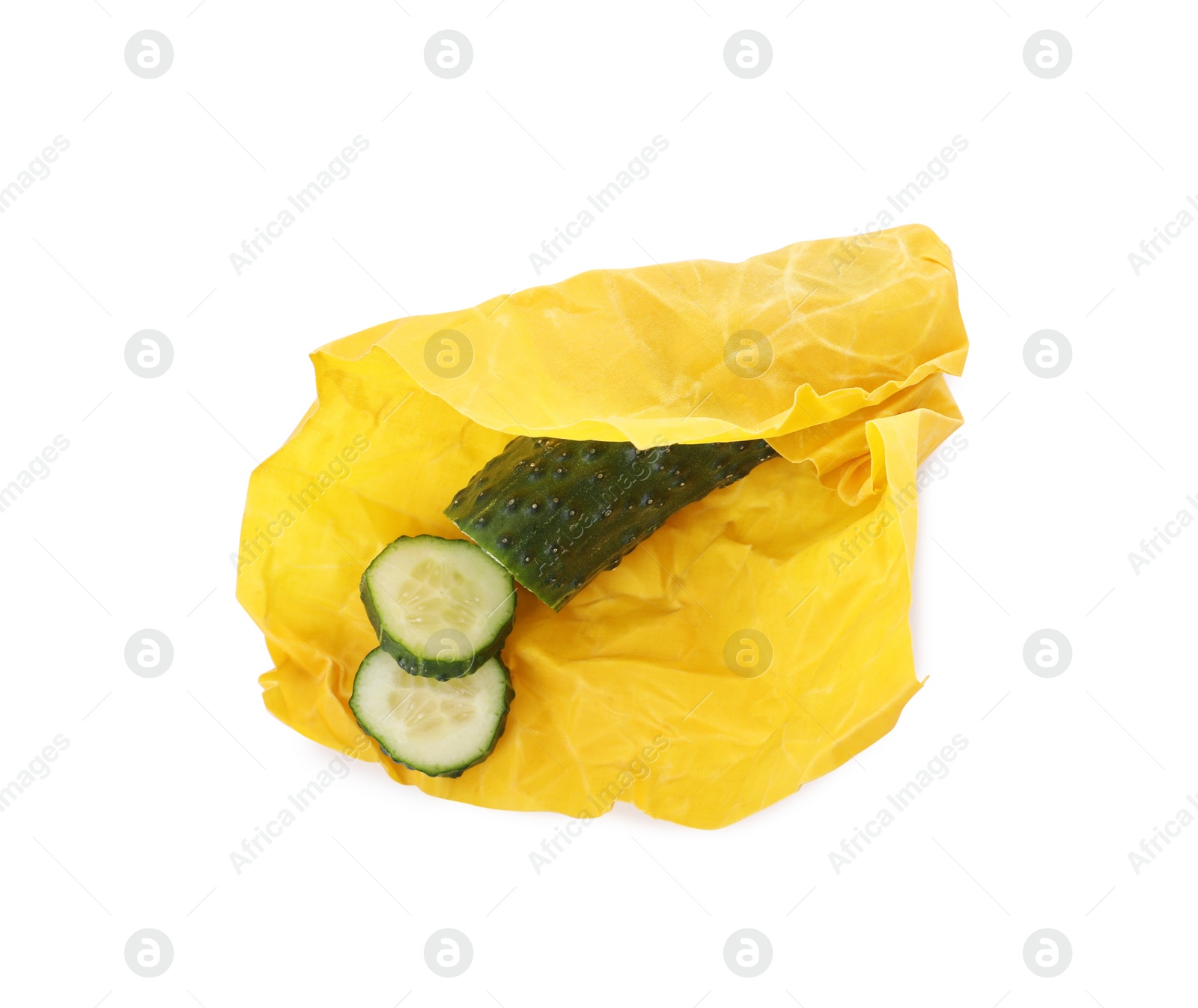 Photo of Fresh cucumber in beeswax food wrap isolated on white, top view