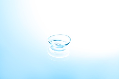 Photo of Contact lens on color glass background