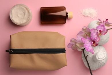 Photo of Preparation for spa. Flat lay composition with toiletry bag and orchid on pink background