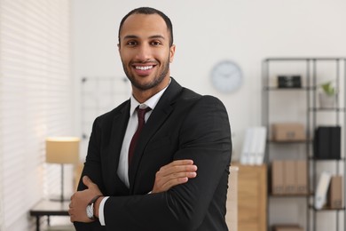 Photo of Portrait of smiling young man in office, space for text. Lawyer, businessman, accountant or manager