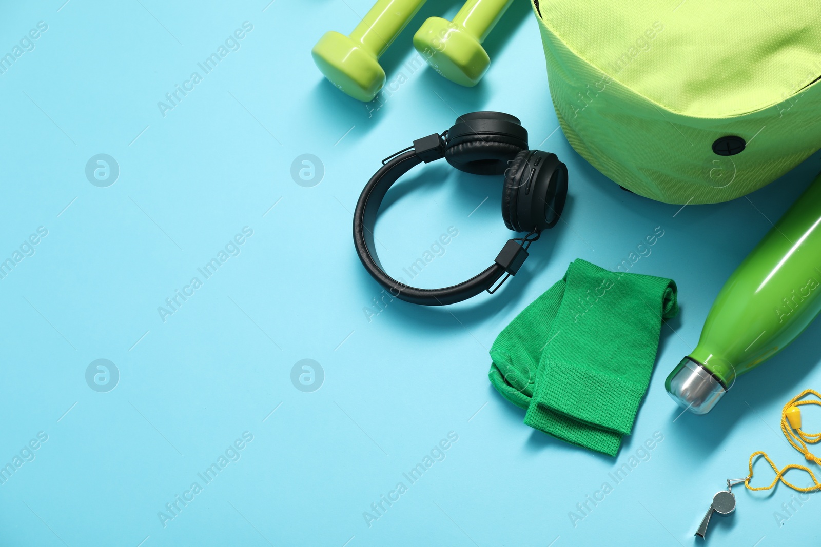 Photo of Different sports equipment on light blue background, flat lay. Space for text