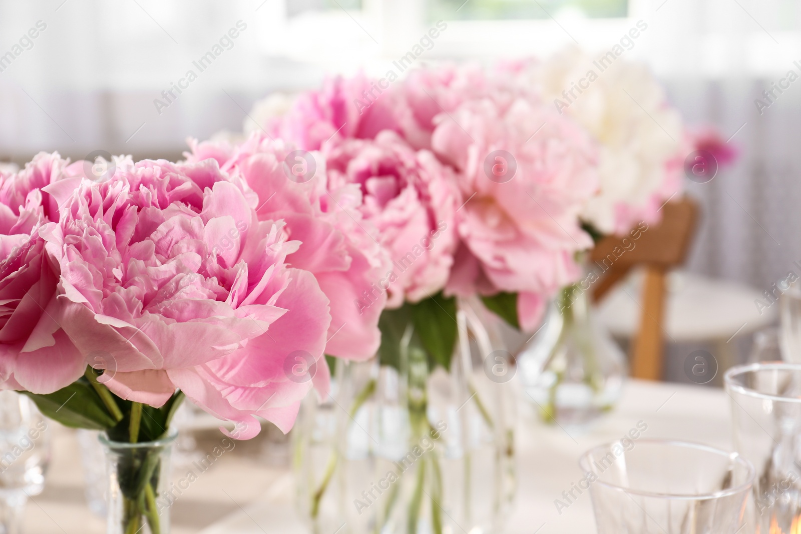 Photo of Stylish table setting with beautiful peonies indoors, closeup. Space for text