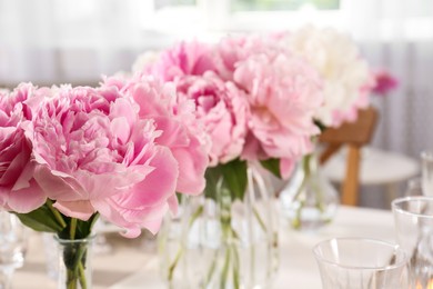 Photo of Stylish table setting with beautiful peonies indoors, closeup. Space for text