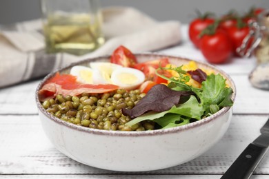 Photo of Bowl of salad with mung beans on white wooden table