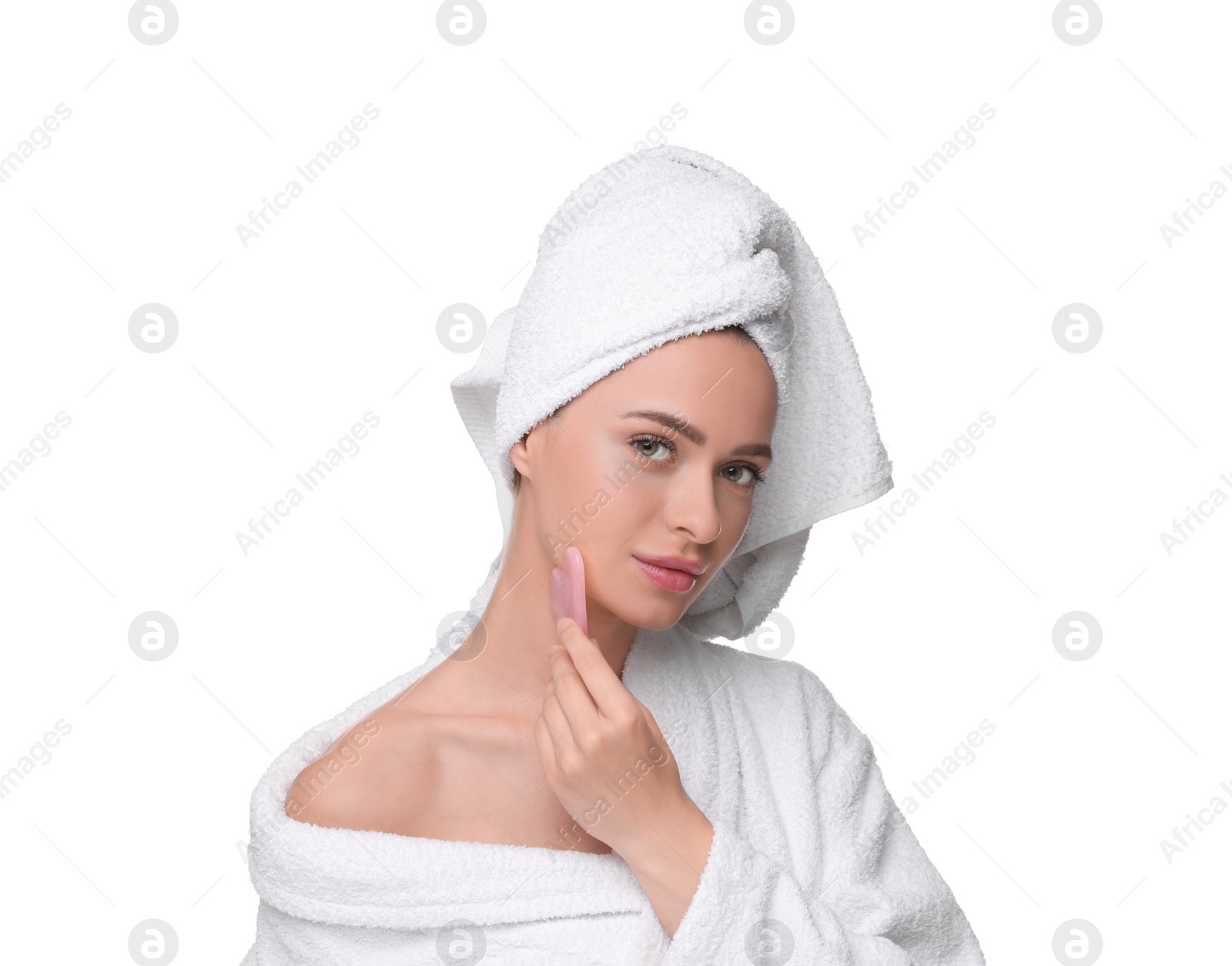 Photo of Young woman massaging her face with rose quartz gua sha tool isolated on white