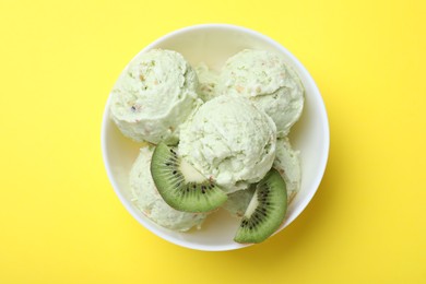 Delicious kiwi ice cream on yellow background, top view