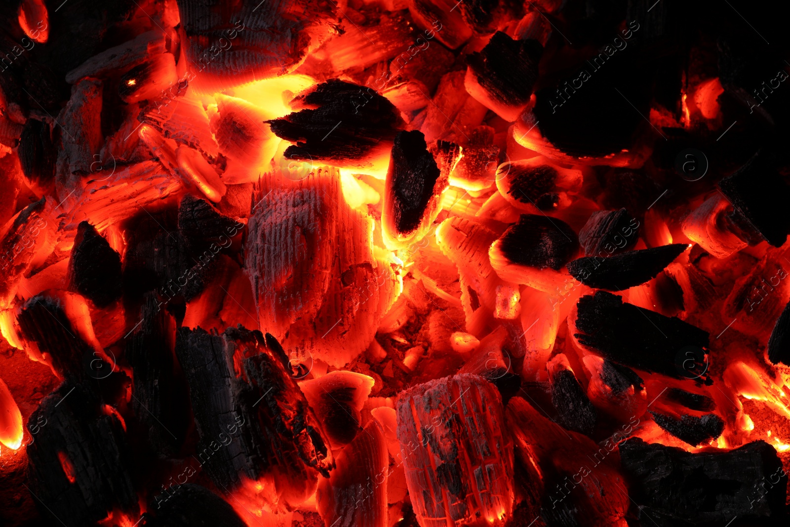 Photo of Pieces of hot smoldering coal as background, top view