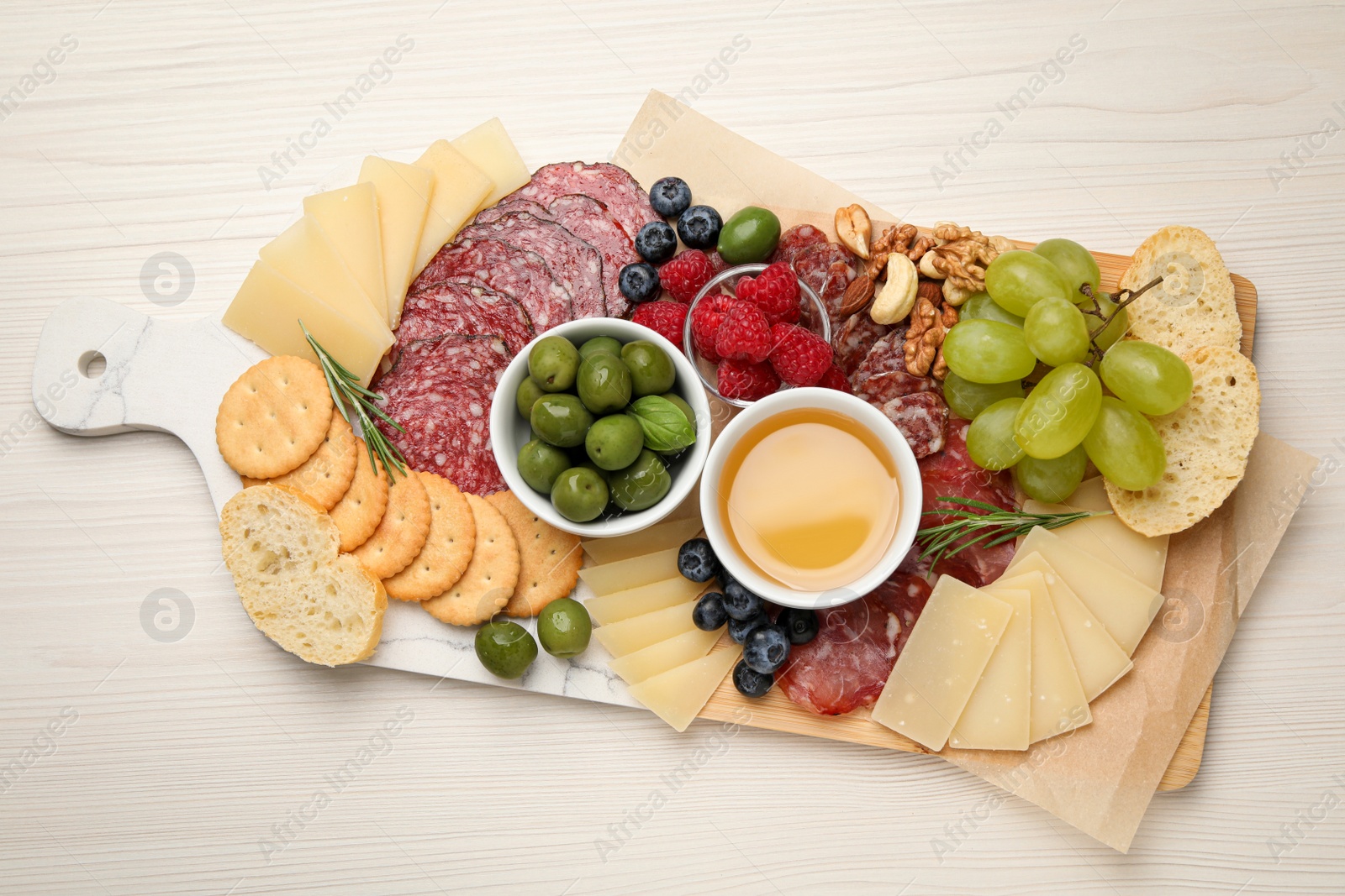 Photo of Snack set with delicious Parmesan cheese on light wooden table, top view