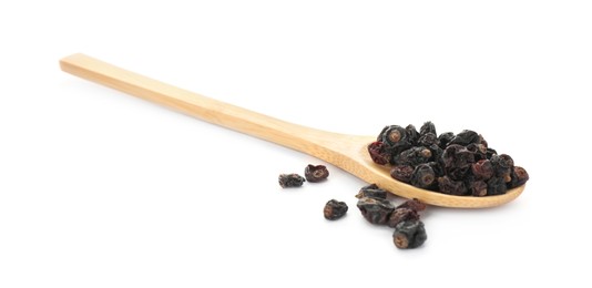 Photo of Dried black currants and wooden spoon isolated on white