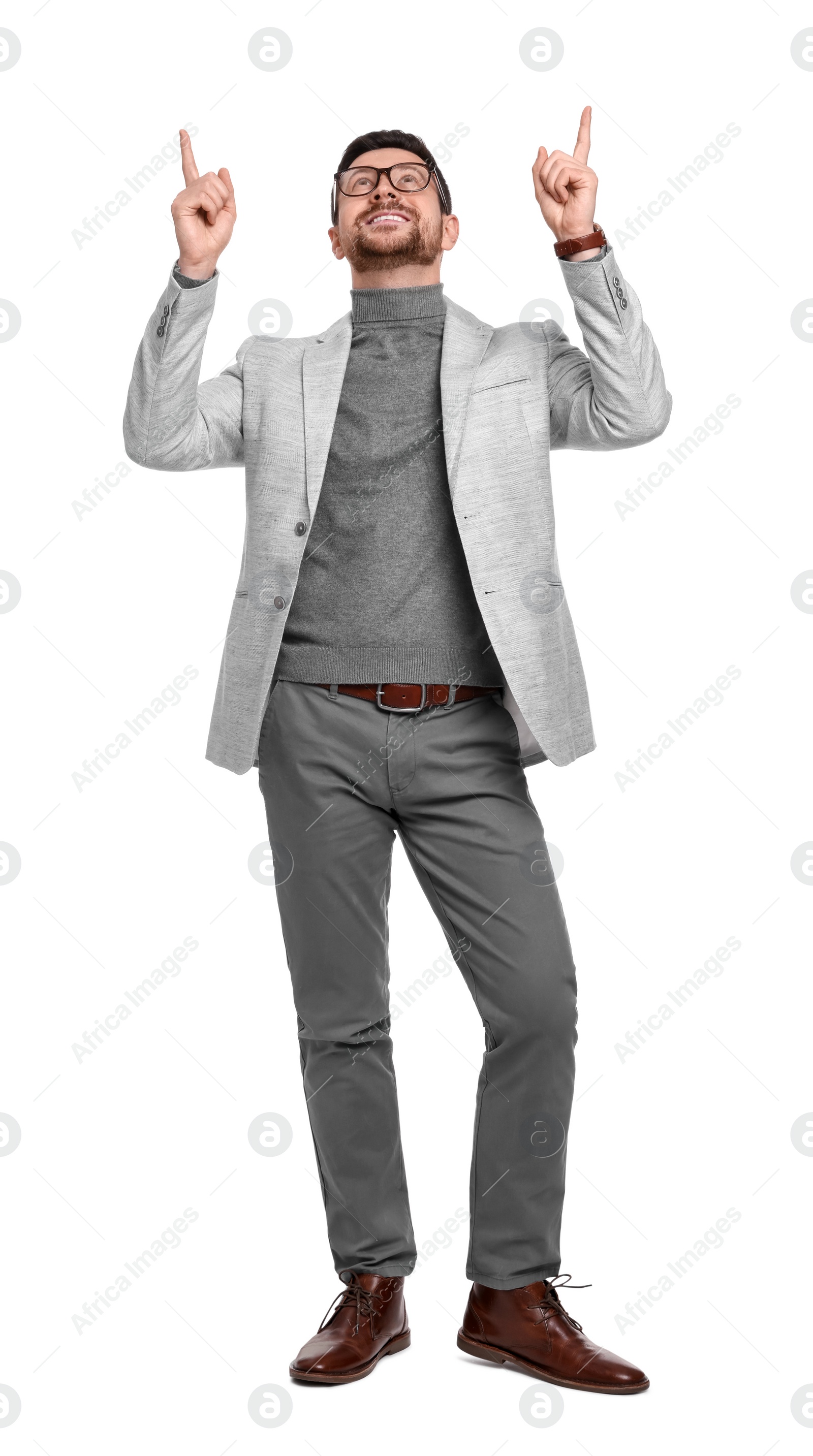 Photo of Handsome bearded businessman in eyeglasses pointing at something on white background