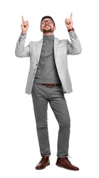 Handsome bearded businessman in eyeglasses pointing at something on white background