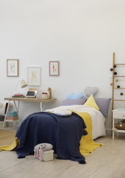 Photo of Modern teenager's room interior with comfortable bed
