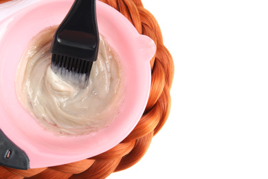 Bowl with dye and brush on white background, top view