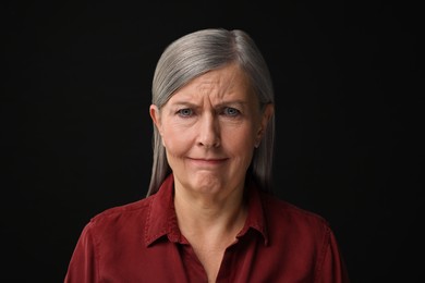 Personality concept. Portrait of emotional woman on black background