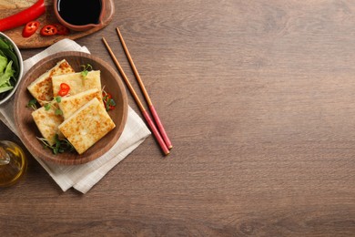 Photo of Delicious turnip cake with microgreens served on wooden table, flat lay. Space for text