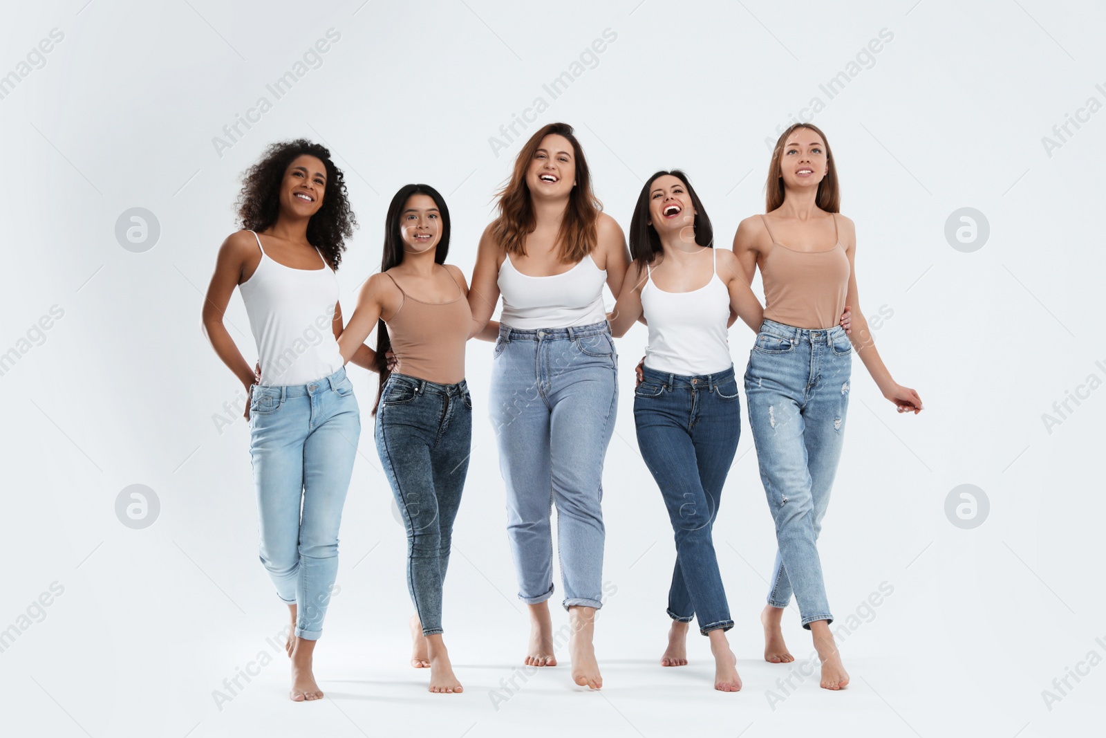 Photo of Group of women with different body types on light background