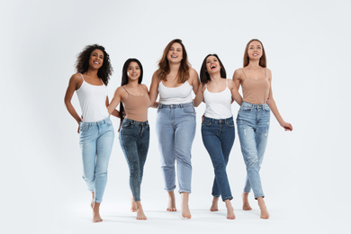 Group of women with different body types on light background