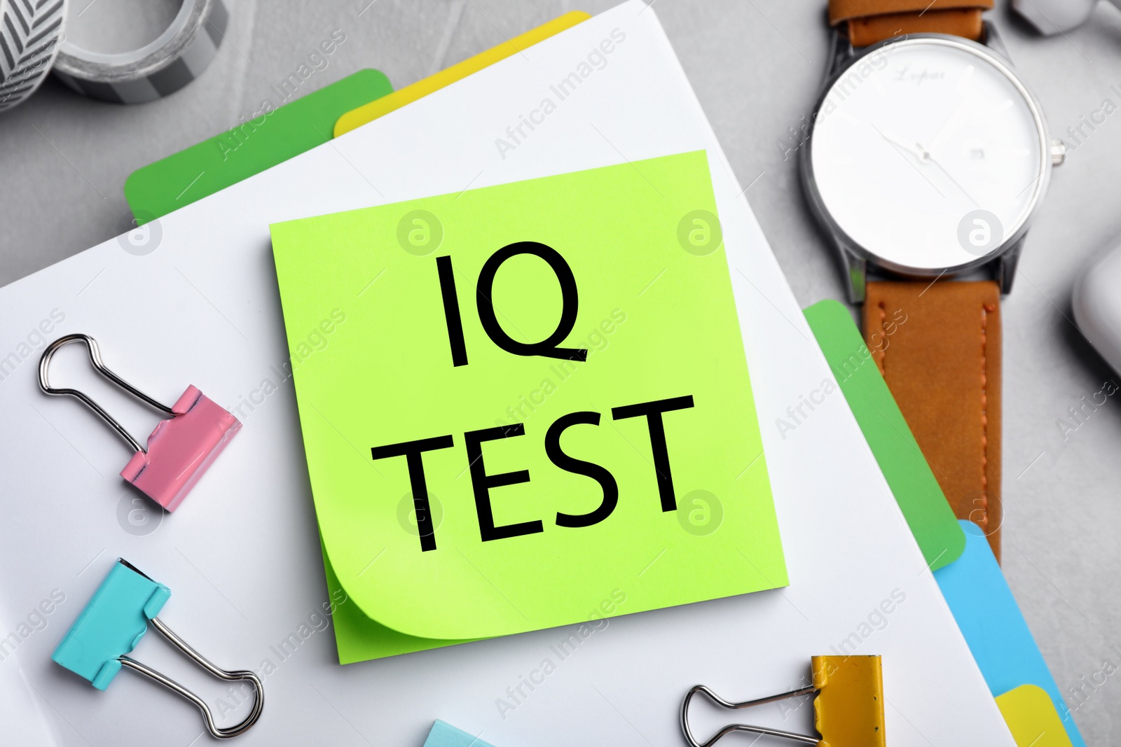 Image of Sticky note with text IQ Test and stationery on table, flat lay