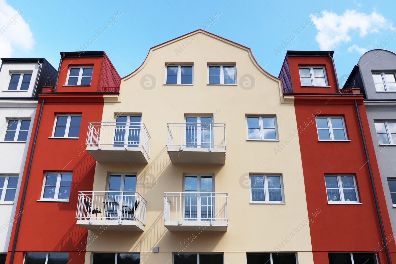 Photo of Modern houses with balconies against blue sky