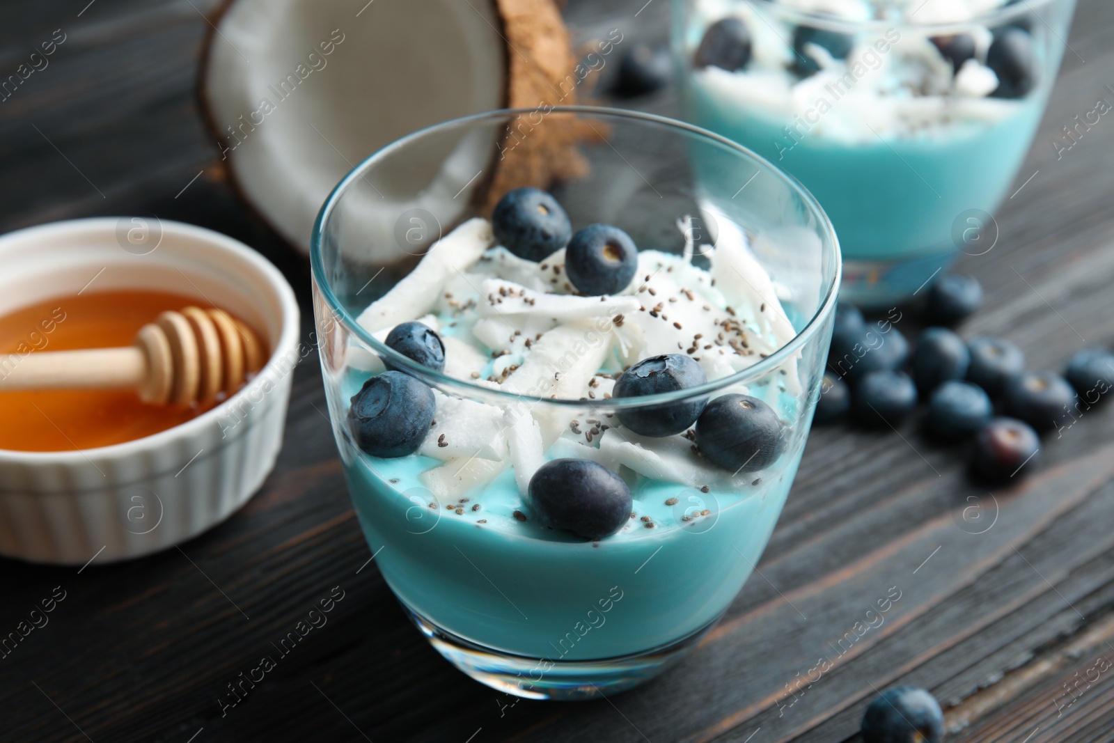 Photo of Composition with glass cup of spirulina smoothie on wooden table