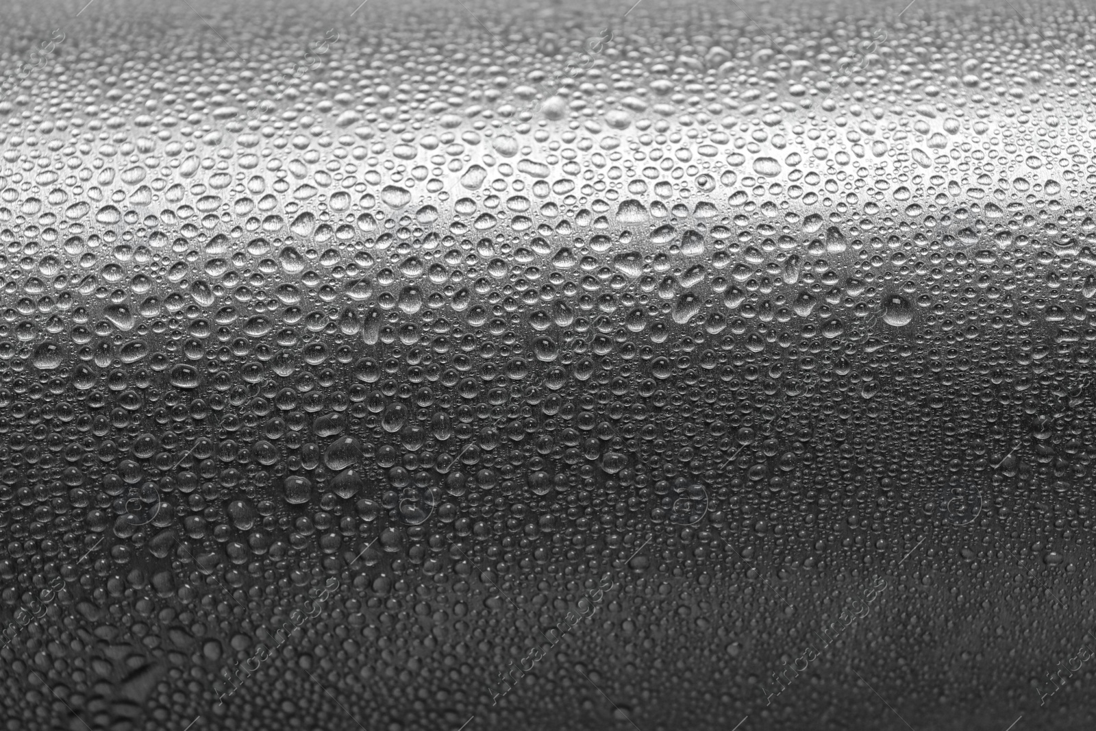 Photo of Aluminum sports water bottle covered with drops, closeup