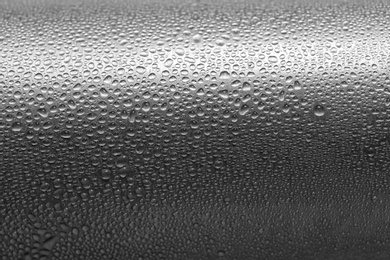 Photo of Aluminum sports water bottle covered with drops, closeup