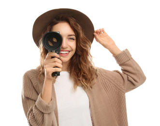 Beautiful young woman using vintage video camera on white background