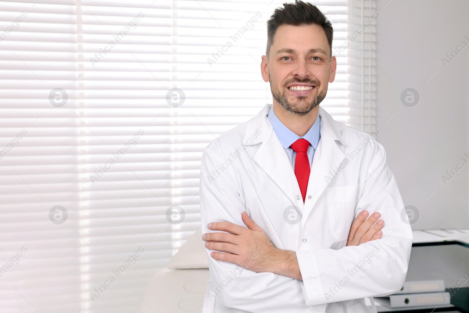 Photo of Happy doctor in clinic, space for text. Patient consultation