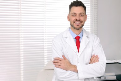 Photo of Happy doctor in clinic, space for text. Patient consultation