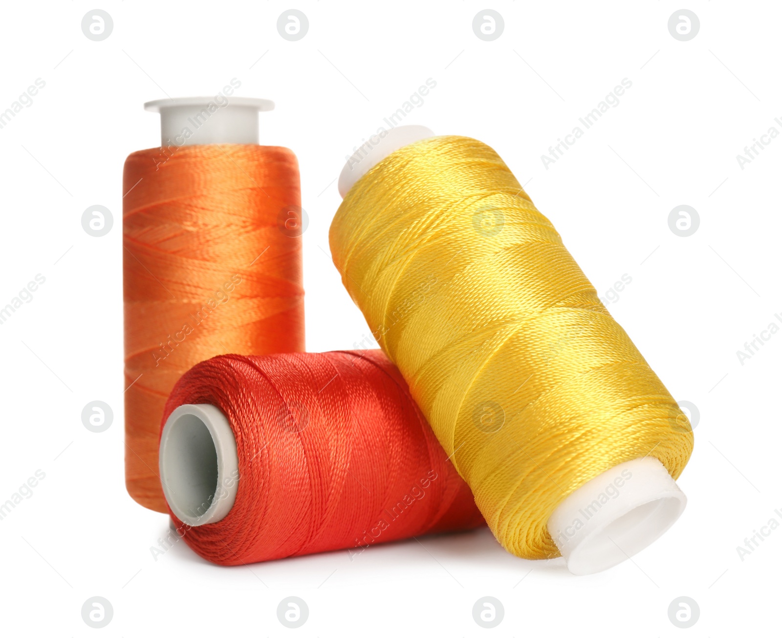 Photo of Different colorful sewing threads on white background