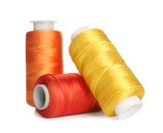Different colorful sewing threads on white background