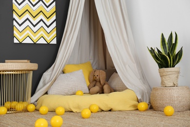 Photo of Baby room interior with play tent and cute posters