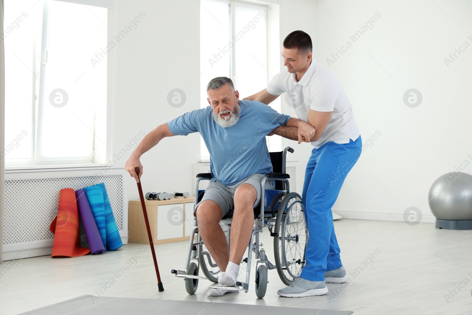 Photo of Professional physiotherapist working with senior patient in rehabilitation center