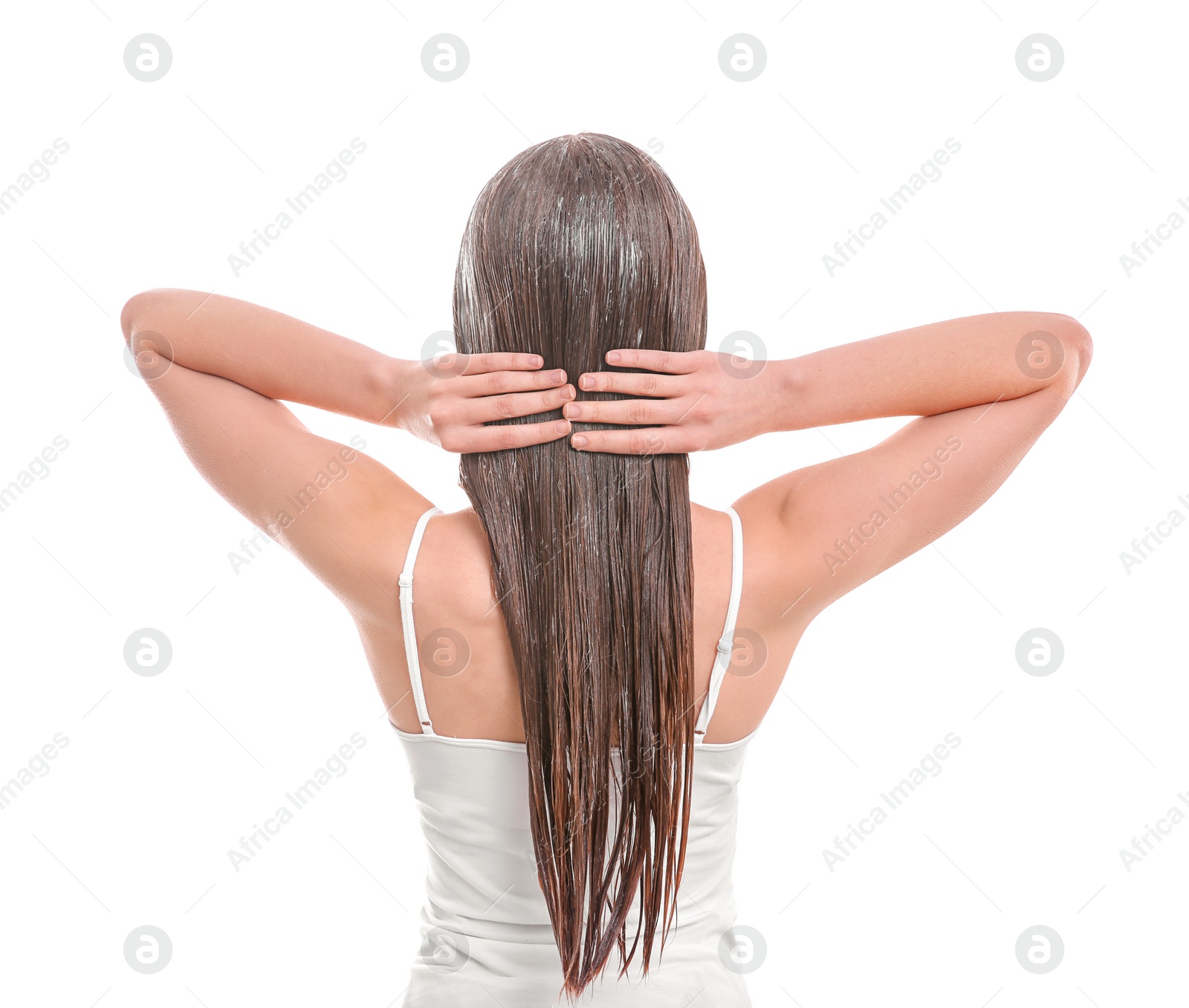 Photo of Young woman applying mask onto hair against white background