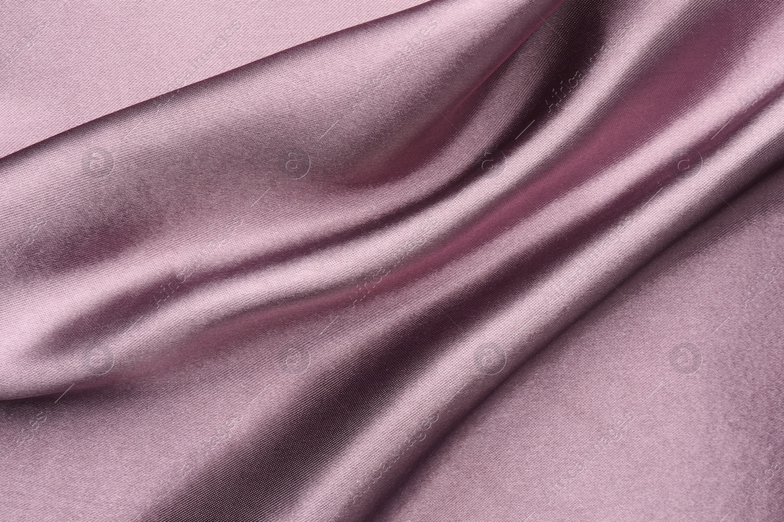 Photo of Crumpled dark purple silk fabric as background, top view