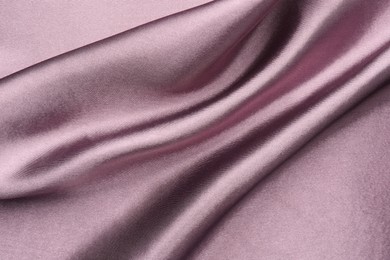 Crumpled dark purple silk fabric as background, top view