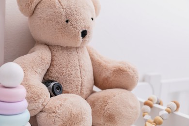Small camera hidden among toys in baby room