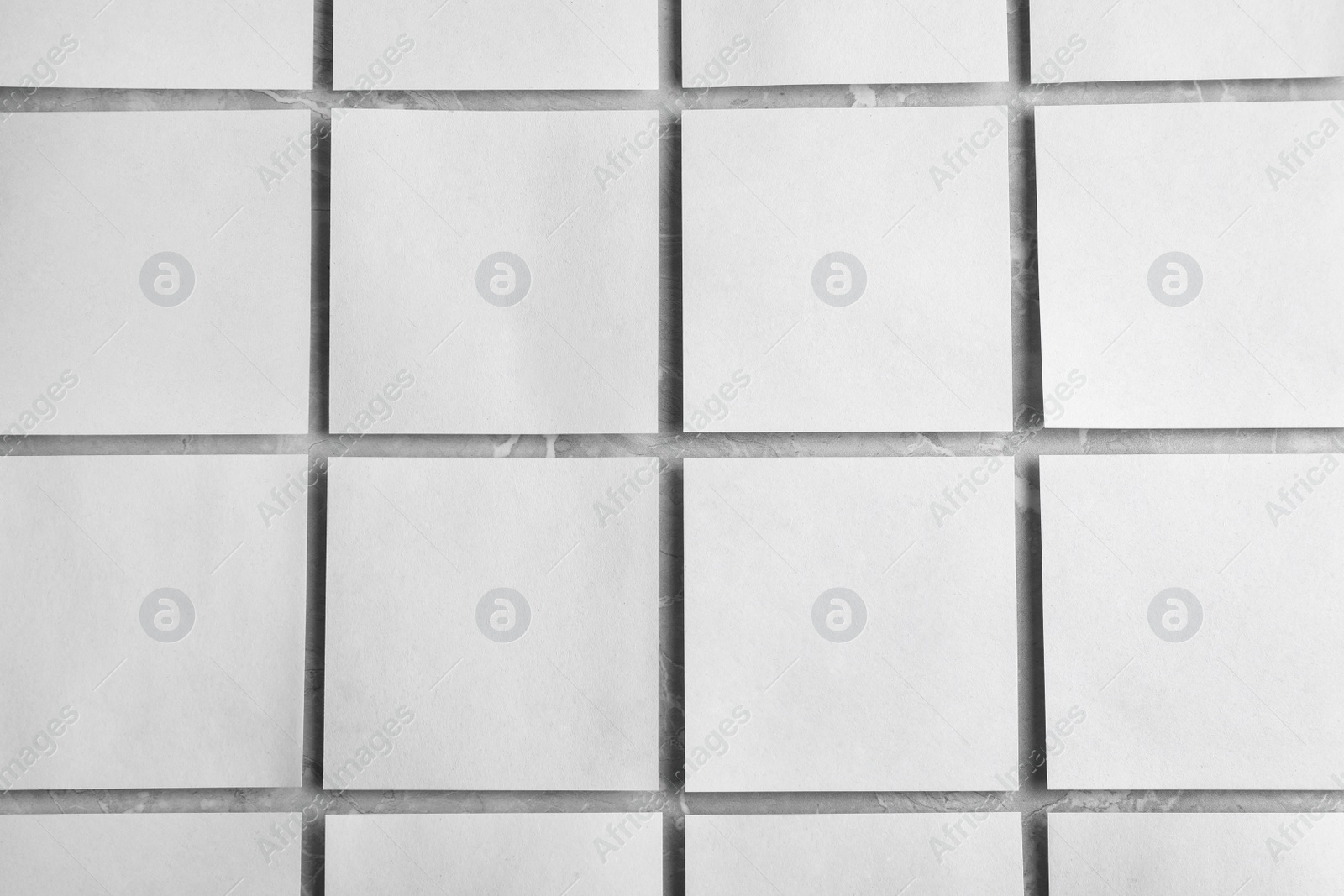 Photo of Blank note papers on light grey marble background, flat lay. Mock up for design