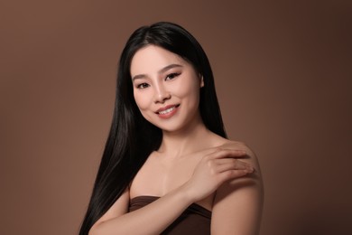 Portrait of beautiful woman on brown background