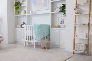 Photo of Newborn baby room interior with stylish crib