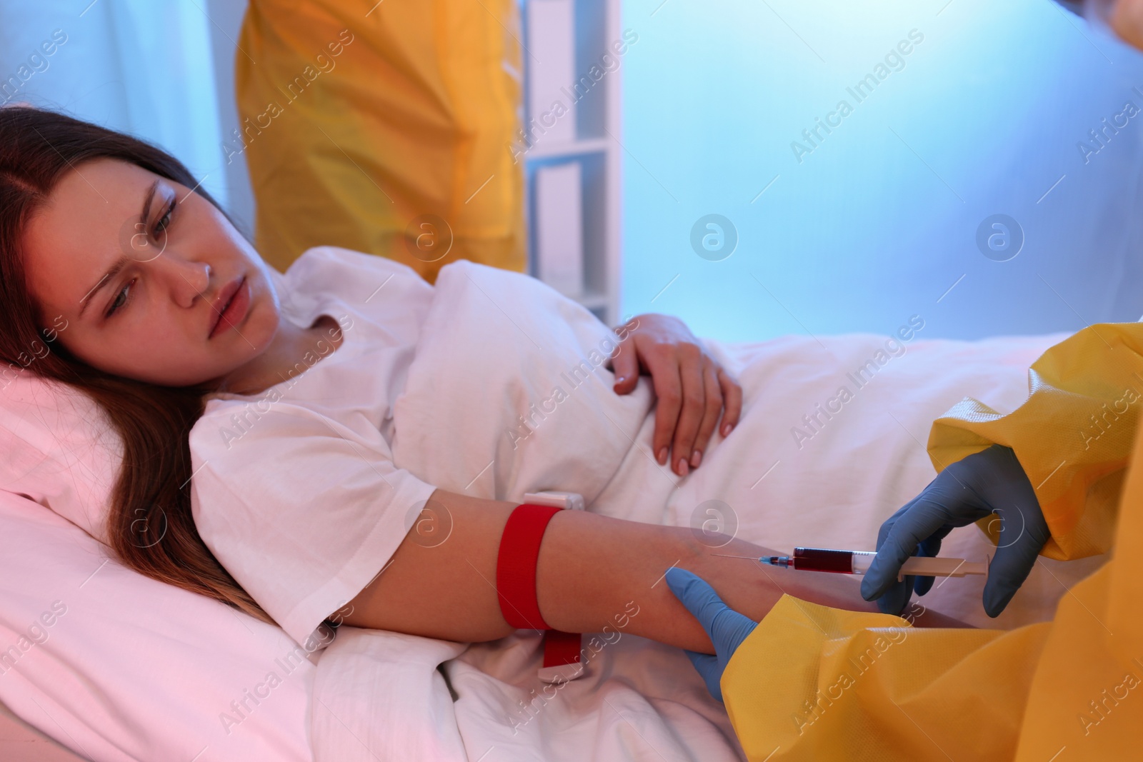 Photo of Patient with virus and paramedics in quarantine ward, closeup