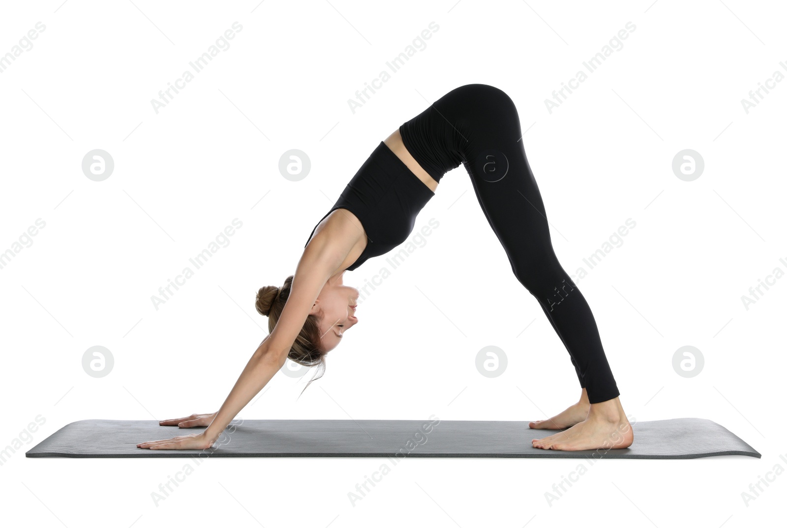 Photo of Young woman in sportswear practicing yoga on white background