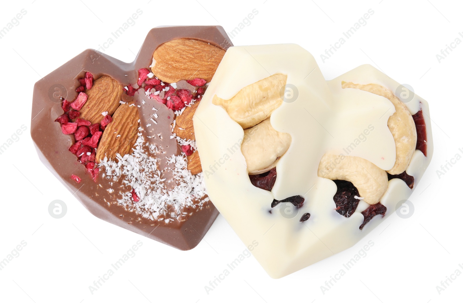 Photo of Tasty chocolate heart shaped candies with nuts on white background, top view