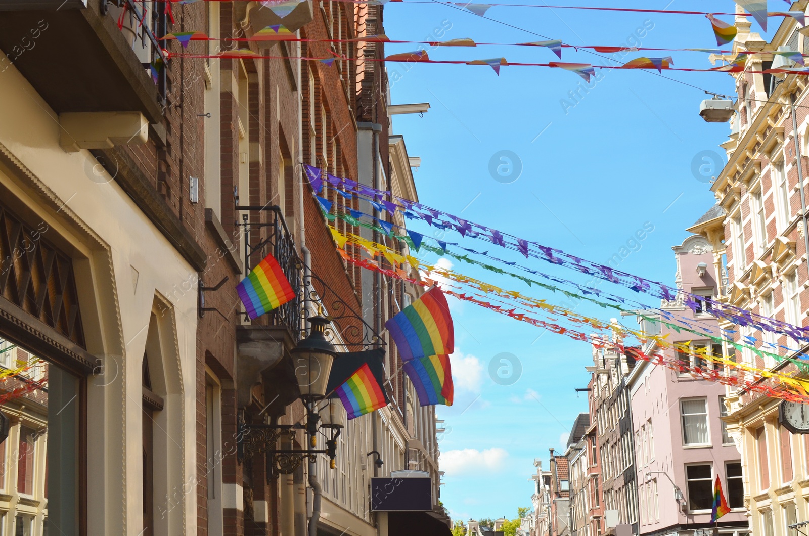 Photo of Bright rainbow LGBT pride flags on building facade