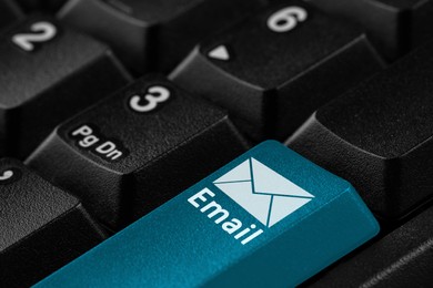 Image of Light blue button with word Email and illustration of envelope on computer keyboard, closeup