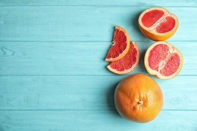 Photo of Fresh tasty grapefruits on color background, top view with space for text