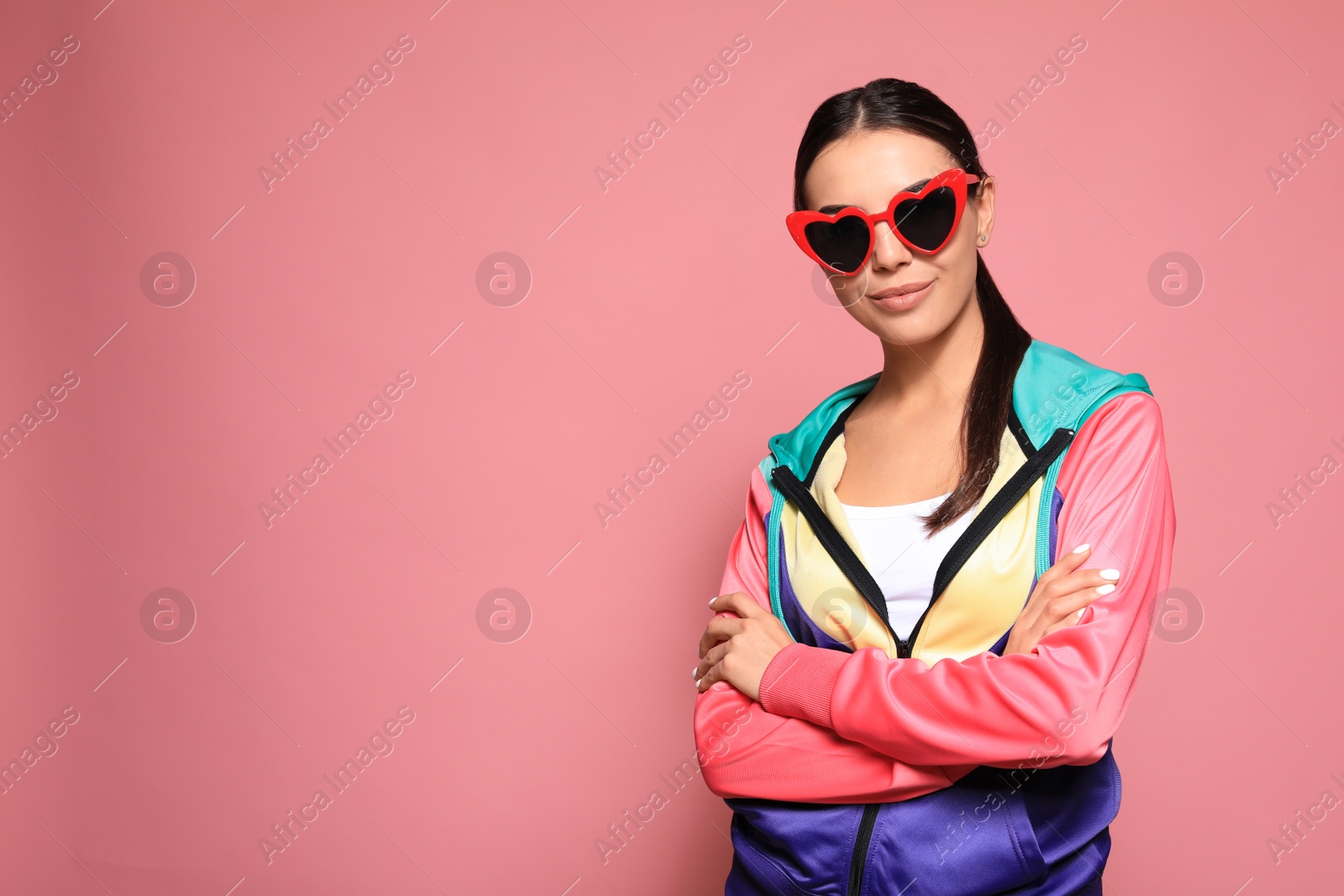 Photo of Portrait of beautiful young woman with heart shaped sunglasses on color background. Space for text