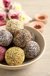 Different delicious vegan candy balls on white wooden table