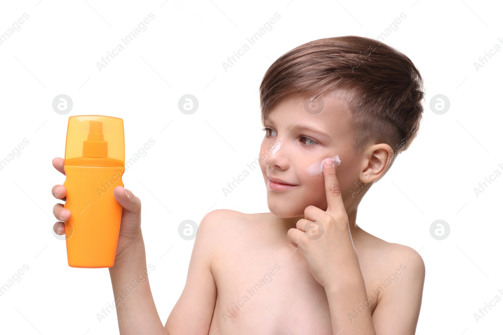 Photo of Smiling boy applying sun protection cream on white background