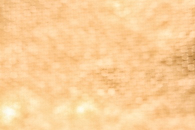 Photo of Blurred view of golden surface as background